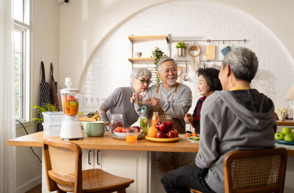 seniors making a meal together in a well lit kitchen