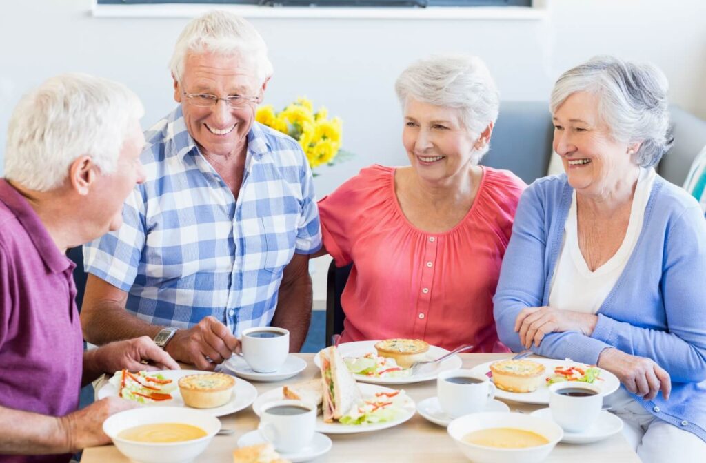 Seniors enjoy conversation over a mealtime in senior living, cultivating community with each other